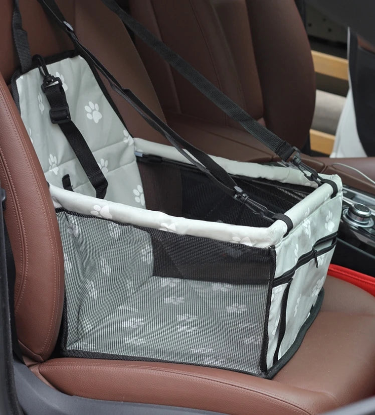 Pet car seat cover with paw print design on a car seat
