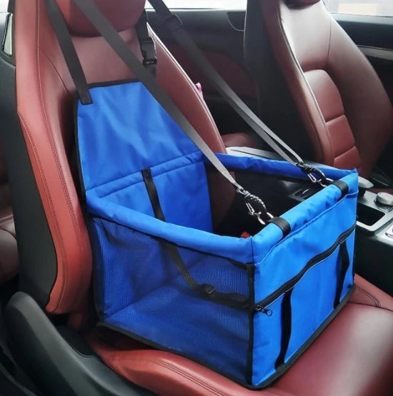 Blue pet seat cover on a car seat with a strap