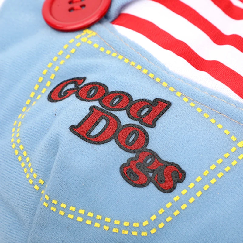 Embroidered text 'Good Dogs' on a denim patch with red button and striped background.