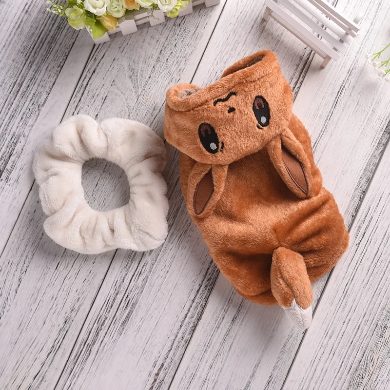 Brown plush bunny toy and white scrunchie on a wooden surface