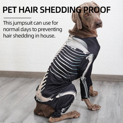 Dog wearing a black and white skeleton-themed jumpsuit on a wooden floor.