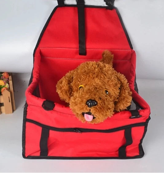 Red pet carrier with a plush dog toy inside on a white background