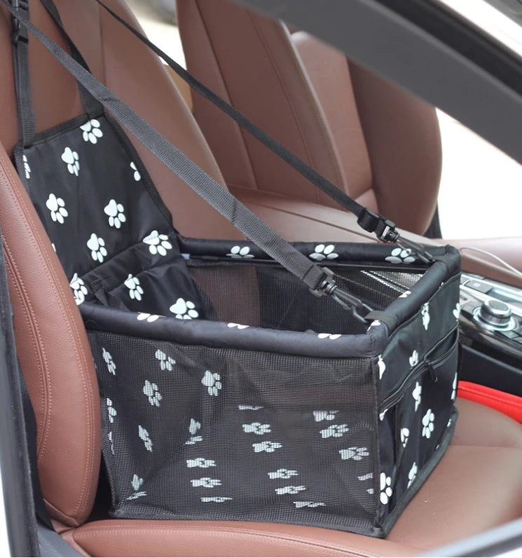 Pet car seat harness with paw print design on a car seat