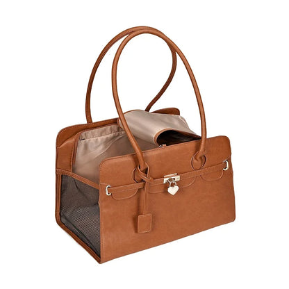 Brown leather pet carrier with a beige interior on a white background