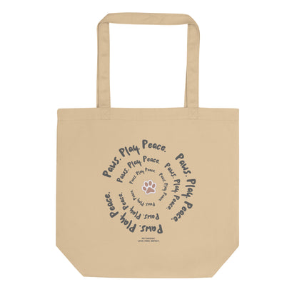 Beige tote bag with text and paw print design on a white background