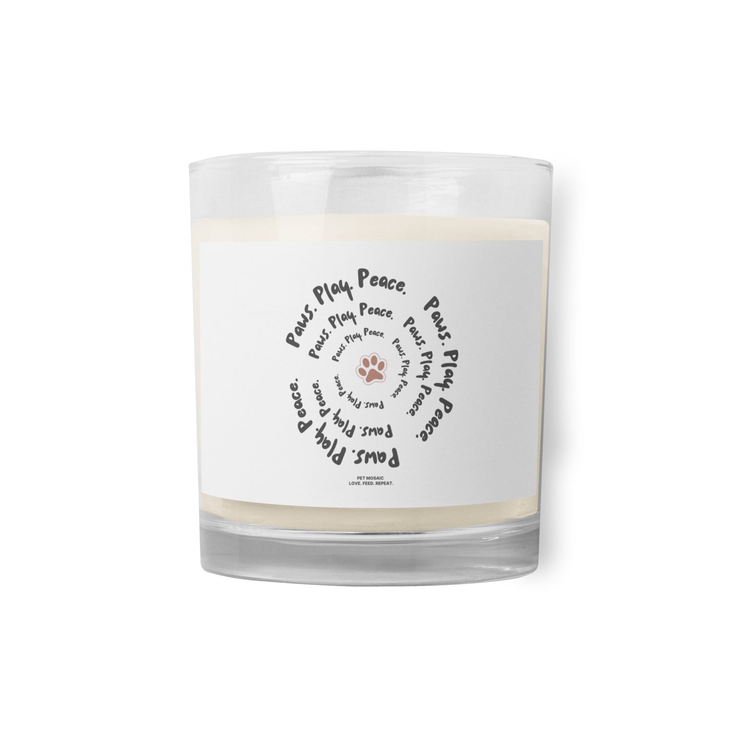 Clear glass candle with a white label featuring text and paw prints on a white background
