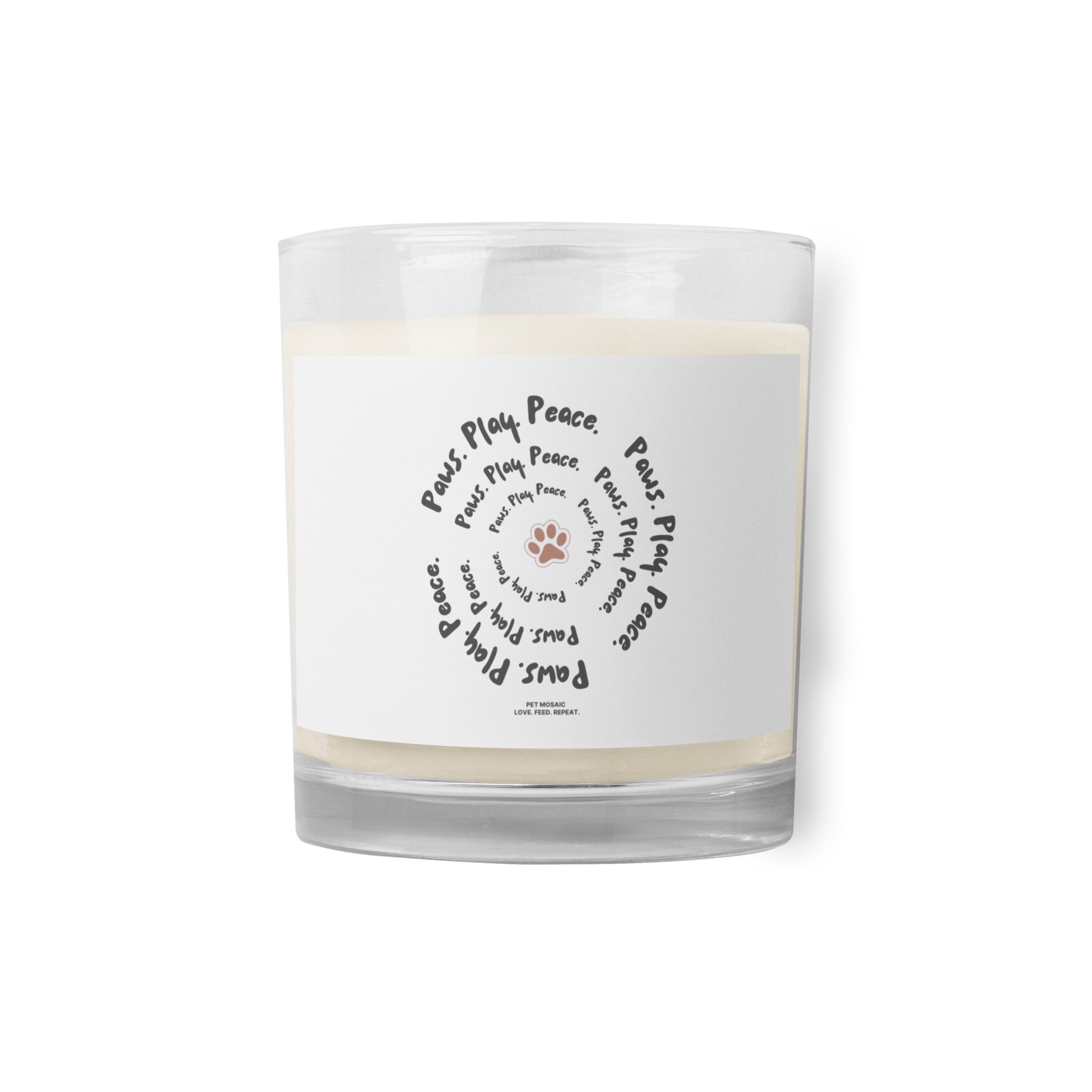 Clear glass candle with a white label featuring text and paw prints on a white background