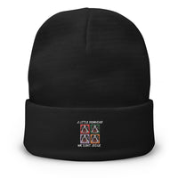Black beanie with embroidered design on a white background