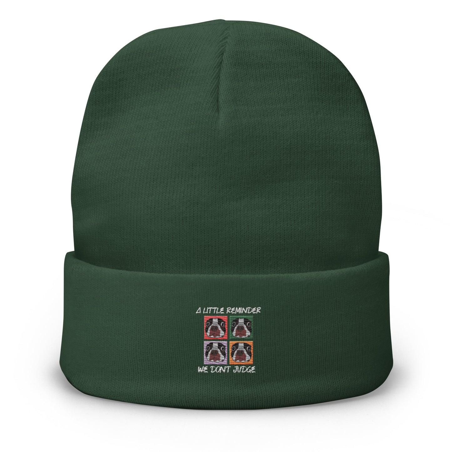 Green beanie with embroidered design on a white background