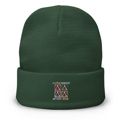 Green beanie with embroidered design on a white background