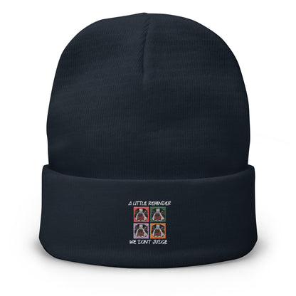 Black beanie with embroidered design on a white background