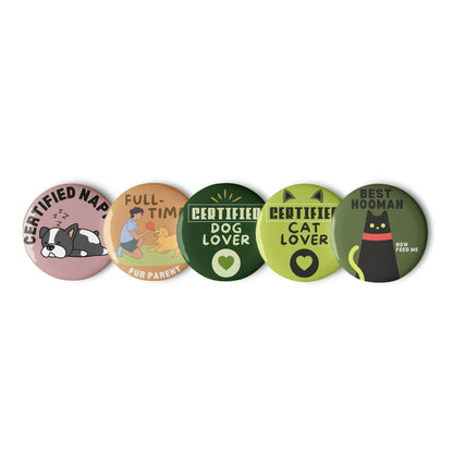 Set of 5 round pin buttons displayed on a white background. Each button features vibrant, glossy designs celebrating love for both cats and dogs, including colorful illustrations of cats and dogs, multi-pet motifs, and playful text elements. The pins have a shiny finish and secure metal backs, showcasing multicolor artwork ideal for pet lovers and collectors.