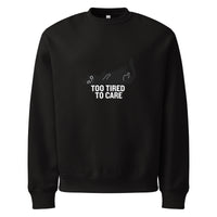 Black sweatshirt with a graphic and text 'Too Tired to Care' on a white background